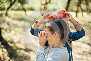 Children with Apple in Orchard. Harvest Concept.