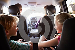 Children In Back Seat Of Car On Journey With Parents photo