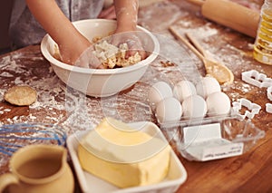 Children, baking and hands in kitchen with dough, home and learning with ingredients for dessert cake. Kids, kneading
