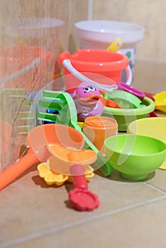 Children bath plastic toys put in the bathroom which have a pink small duck in the middle.