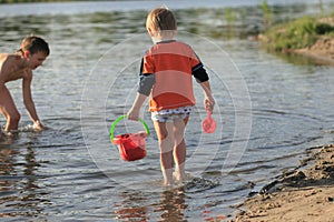 Children bathe in the evening on the city beach photo