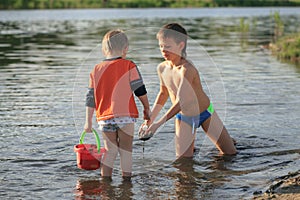 Children bathe in the evening on the city beach