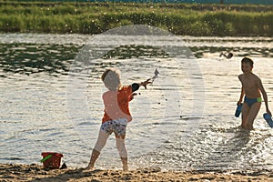 Children bathe in the evening on the city beach photo