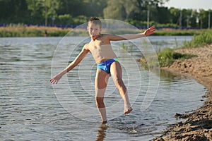 Children bathe in the evening on the city beach photo