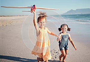 Children, beach vacation and travel with happy girl sisters or siblings flying airplane toy running by seaside for fun