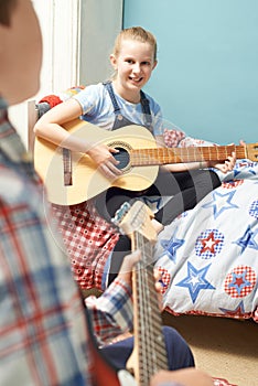 Children In Bedroom Playing Guitars Together