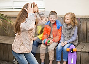 Children on bench playing children`s games