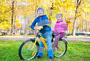 Children on bicycle in autumn park