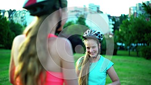 Children in bicycle helmet go on hill walk bike