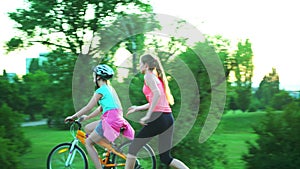 Children in bicycle helmet go on hill walk bike