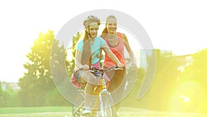 Children in bicycle helmet teach ride bike in summer park