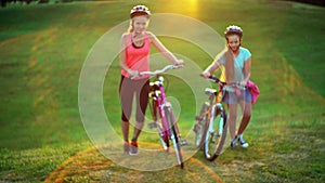 Children in bicycle helmet top hill walk bike