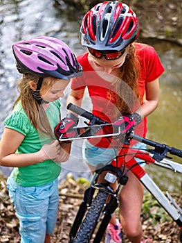 Children bicycle with tablet PC searching way into internet map.