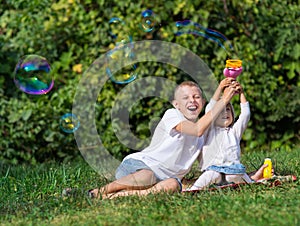 Children blow bubbles