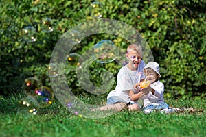 Children blow bubbles