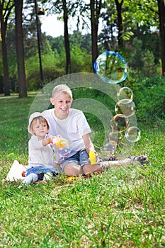 Children blow bubbles