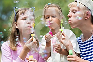 Children blowing soap bubbles