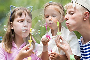 Children blowing soap bubbles