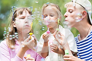 Children blowing soap bubbles