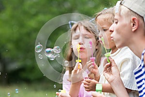 Children blowing soap bubbles