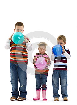 Children blowing up toy balloons