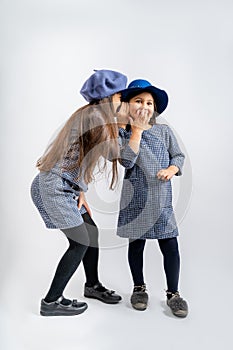 Children in a blue jacket with white and black spots, a blue cap, blue shorts with the same spots, black tights, black shoes, a bl photo