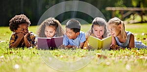 Children, books and lying in park with friends, learning or diversity for reading at school playground. Kids, education
