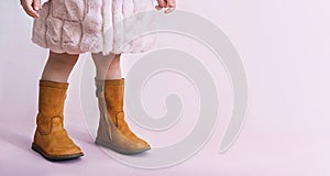 children boots shoes for little fashionistas on a pink background copyspace for text photo