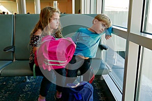 Children bored at the aiport while waiting for a flight