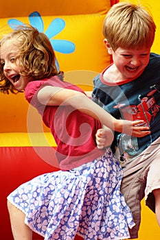 Children playing on a bouncy castle photo