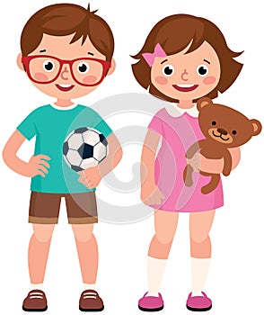 Children boy and girl holding toy teddy bear and soccer ball photo