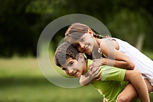 Children boy and girl in love running piggyback park