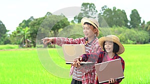 Children boy holding laptop and kids girl wearing virtual reality glasses