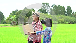 Children boy holding laptop and kids girl wearing virtual reality glasses