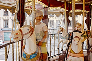 Children, boys, going on Merry Go Round, kids play on carousel in the summer