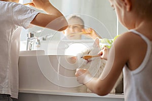 Children brother and sister wash and brush their teeth in the bathroom