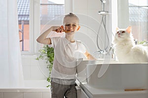 Children brother and sister wash and brush their teeth in the bathroom