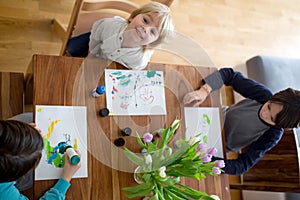 Children, brothers, drawing with aquarel paints at home