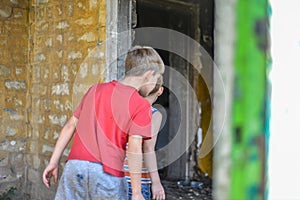 Children in a burnt house lost their homes as a result of hostilities and natural disasters