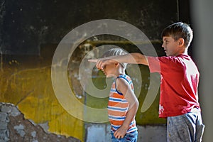 Children in a burnt house lost their homes as a result of hostilities and natural disasters