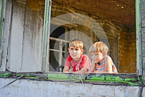 Children in a burnt house lost their homes as a result of hostilities and natural disasters