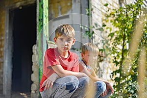 Children in a burnt house lost their homes as a result of hostilities and natural disasters