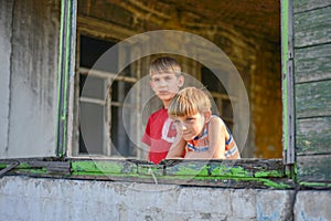 Children in a burnt house lost their homes as a result of hostilities and natural disasters