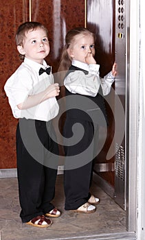 Children in business suit in elevator. photo