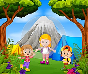 Children camping out in the park with mountain scene