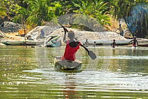 Children canoe in the river Gambia