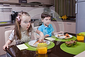 Children captivated by a TV show while eating