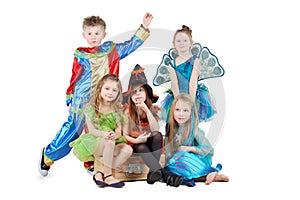 Children in carnival costumes sit on chest