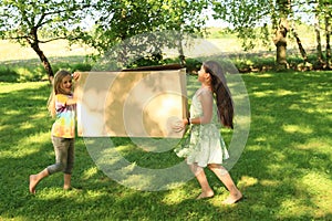 Children carrying a box