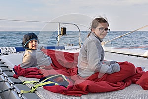 Children on a catamaran relaxing
